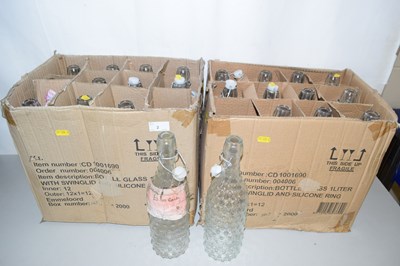 Lot 2 - Two boxes of swing lid glass bottles