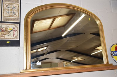 Lot 36 - A modern arched topped over mantel mirror in...