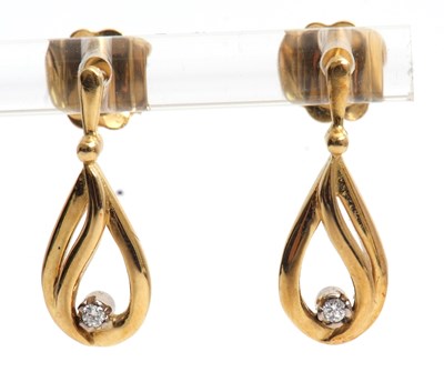Lot 90 - A pair of diamond earrings, the pear shape...
