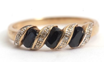 Lot 64 - A 9ct sapphire and diamond highlight ring,...