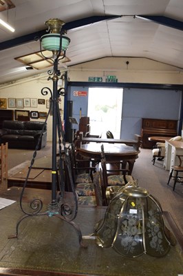 Lot 299 - An iron framed standard oil lamp together with...
