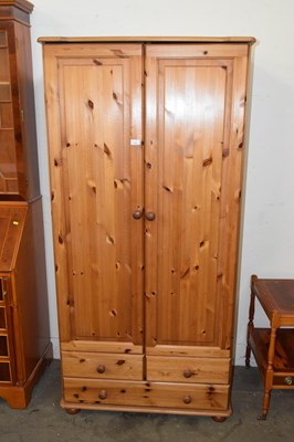 Lot 735 - Two door pine wardrobe with tables below