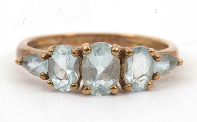 Lot 48 - A 9ct topaz ring, with three graduated oval...