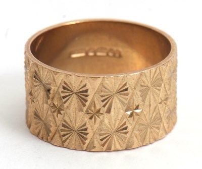 Lot 193 - A 9ct ring, 11mm wide with all around textured...
