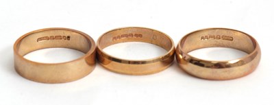 Lot 195 - Three 9ct wedding bands: one hallmarked London...