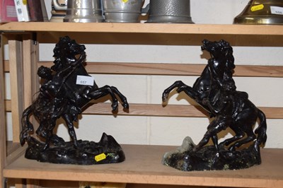 Lot 557 - A pair of cast ornamental figures of rearing...