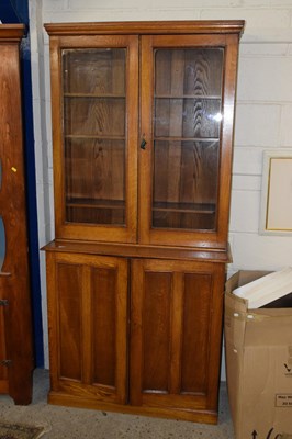 Lot 265 - A late 19th Century oak two piece bookcase...