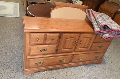 Lot 343 - A modern light oak finish side cabinet with...