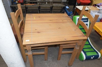 Lot 728 - A pine square kitchen table and two chairs