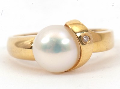 Lot 57 - An 18ct cultured pearl and diamond ring, the...