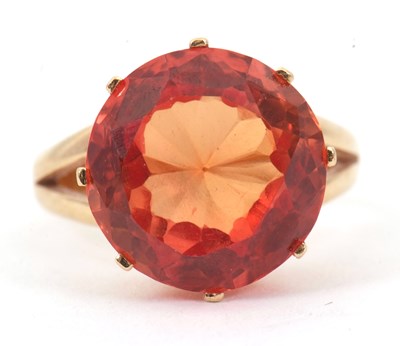 Lot 45 - A 14K orange sapphire ring, the round mixed...