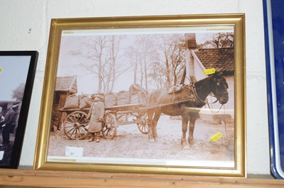 Lot 31 - A monochrome photograph of a coal merchant...