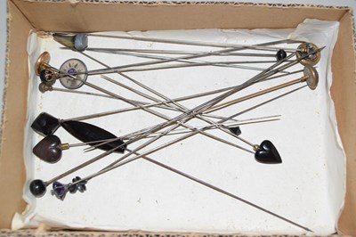 Lot 104 - A group of hat pins