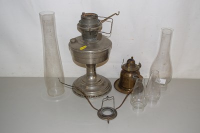 Lot 192 - Two oil lamps plus extra chimneys