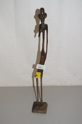 Lot 243 - An abstract cast metal figure of an African...