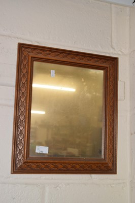 Lot 289 - A rectangular wall mirror in carved dark wood...
