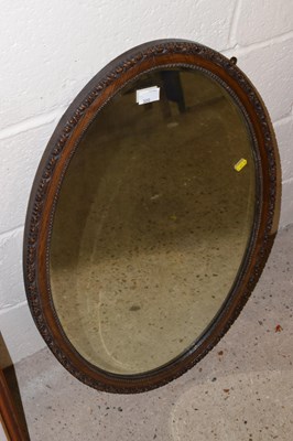 Lot 300 - An oval oak framed wall mirror