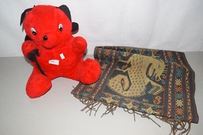 Lot 507 - A soft toy devil and a small floor rug