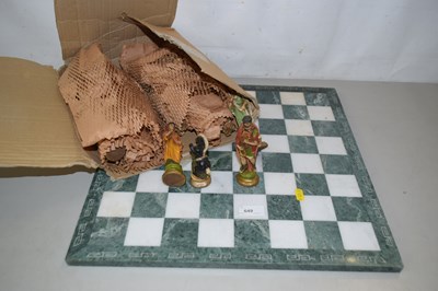 Lot 649 - A moulded resin chess set and board