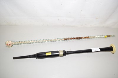Lot 87 - A glass swagger stick with beadwork interior...