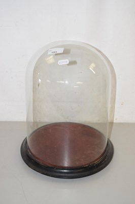 Lot 193 - A vintage glass dome with turned wooden base,...