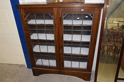 Lot 287 - An early 20th Century oak lead glazed book case