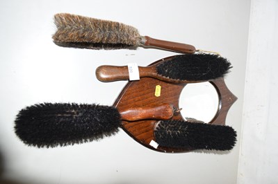 Lot 520 - A vintage wall mounted brush set