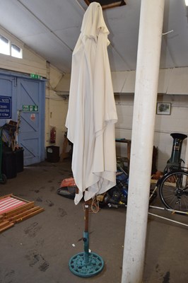 Lot 775 - A garden parasol with iron base