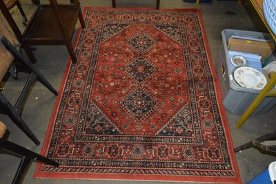 Lot 788 - Machine made red ground floor rug