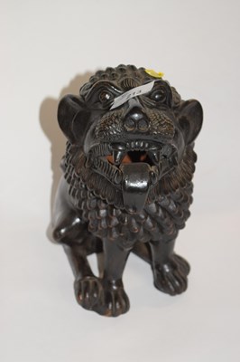 Lot 213 - A terracotta black painted figure of a temple...
