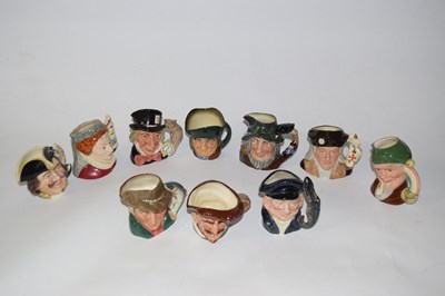 Lot 327 - A collection of small character jugs including...