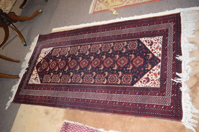 Lot 496 - A 20th Century Afghan wool floor rug decorated...