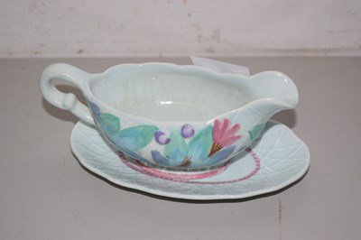 Lot 65 - A Clarice Cliff Newport Pottery sauce boat and...