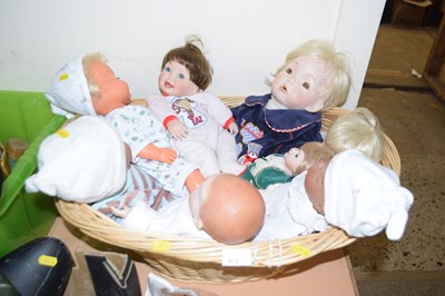 Lot 675 - A basket and a quantity of dolls